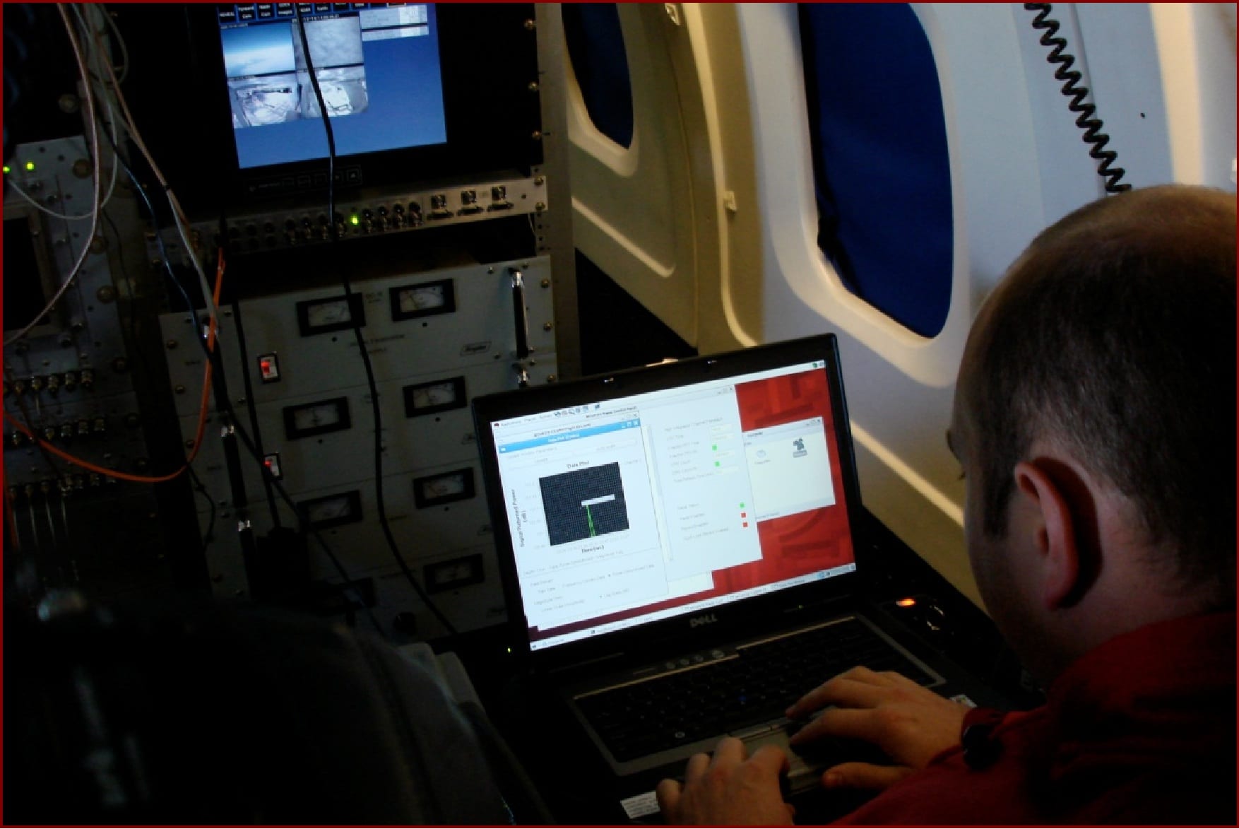 CReSIS graduate student William Blake operates a radar system on board the NASA DC-8 during the fall 2009 OIB field campaign in Antarctica.